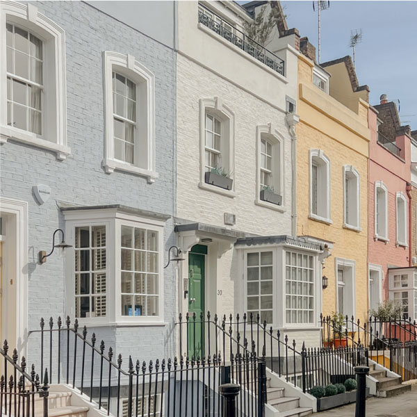 Pastel colour terraced houses in Chelsea London on first day of spring